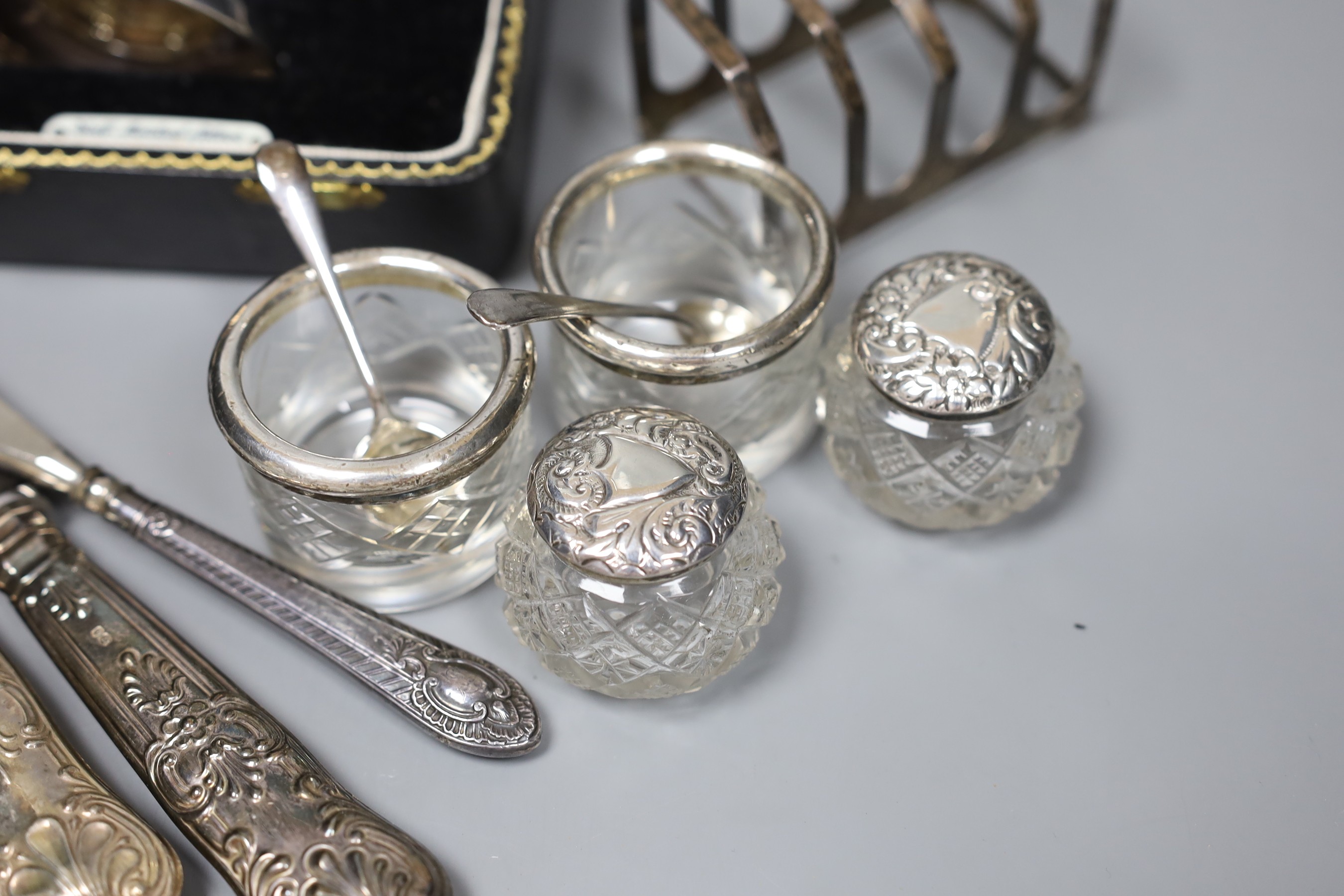 An Art Deco design silver christening can, Birmingham 1961, with fitted case, a toastrack and seven silver mounted items, 5 oz of weighable silver